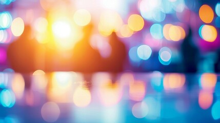 Fototapeta premium Abstract blurred background of colorful lights and silhouettes at a night event.
