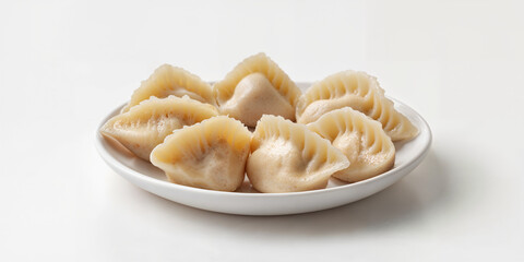 Steamed dumplings arranged neatly on a white plate ready for serving in a bright kitchen environment