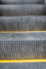 Close up to escalator yellow steel line.