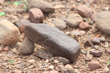 A close-up view of a black stone on the ground