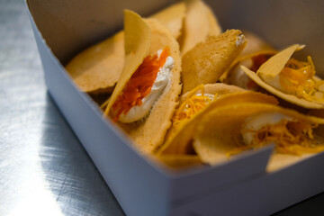 Khanom Buang or Thai crispy pancake in paper box. Close up