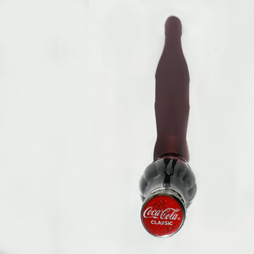 Coca Cola bottle close up from top  with recognisible classic shadow