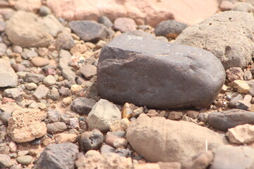 A close-up view of a black stone on the ground