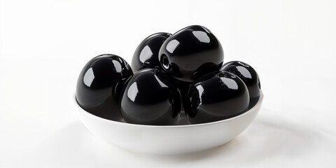 Black olives arranged in a white bowl on a clean surface at a contemporary kitchen setting
