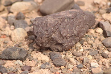 A close-up view of a black stone on the ground