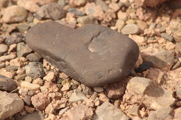 A close-up view of a black stone on the ground