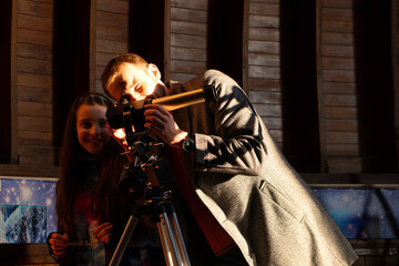 Man and girl enjoy solar telescope observation together