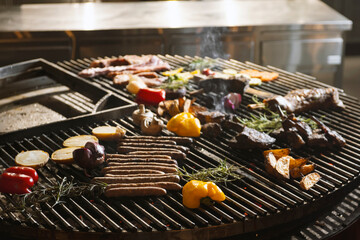 roasted meat and vegetables on the grill with flames and vegetables, close up