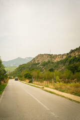 Warm landscape along a road with a cloudy sky