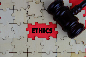 Ethics words on the missing part of wooden puzzle with letters, ethics moral philosophy concept,...