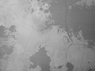 Abstract wall surface featuring irregular patterns, cracks, and a mix of gray shades.