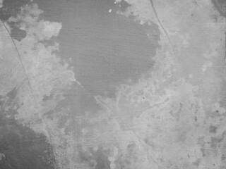 Textured wall with a mix of light and dark patches, showcasing a weathered appearance.