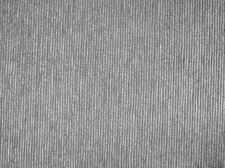 Close-up of a textured fabric, featuring a light gray color with a soft, woven appearance.