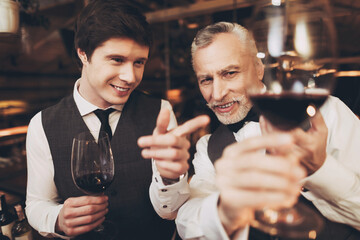 Two men sommelier tasting wine in restaurant. Tasting of elite drinks.
