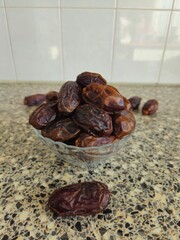 Dates in a bowl on a wooden background. Dried fruits. Dried date fruit. PNG, Ramadan. Organic dried medium fruit snack. Dried date palm.