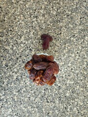 Dates in a bowl on a wooden background. Dried fruits. Dried date fruit. PNG, Ramadan. Organic dried medium fruit snack. Dried date palm.
