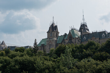 Fototapeta premium Close-up of a historic Parliament building with gothic architecture and green copper roofs in Ottawa, Canada.