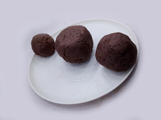 Deliciously Cooked Finger Millet Balls on a White Background. Nutritious Finger Millet Balls (Ragi Mudde) Served on a Clean White Background. Freshly Cooked Finger Millet Balls on a Minimalist White