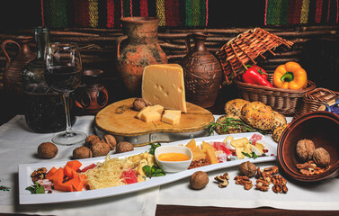 Gourmet cheese board with red wine, walnuts, and fresh bread