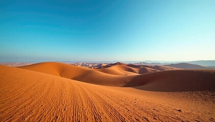 Rolling hills of chocolate brown landscape under clear blue sky, brown, sunny