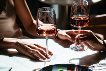 Glasses of rose wine seen during a friendly party or a celebration in a restaurant of a bar.