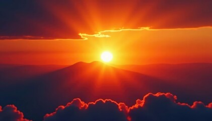 Fototapeta premium A brilliant orange sun sinks slowly below a wispy cloud layer, warm tones, fading glow