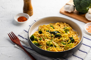 Spaghetti aglio e olio with broccoli, Garlic ,Chili flakes ,Olive Oil and Parmesan Cheese in white plate.