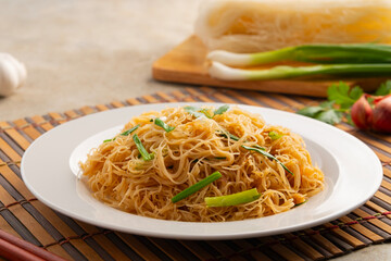 Stir Fried Rice Vermicelli Noodles With Tamarind Sauce in white plate.