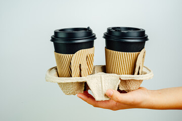 Take away coffee paper cup on pink background. Coffee go to
