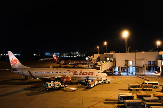 Bangkok,Thailand - May 3, 2023 : An Air India Boeing Dreamliner parked at an aerobridge, illuminated by the setting sun at Delhi Airport, awaits its next journey.