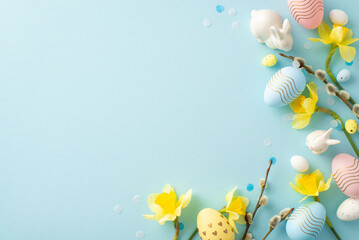 Festive Easter composition featuring pastel eggs, yellow daffodils, and ceramic bunnies on a soft blue background, perfect for seasonal and holiday-themed projects