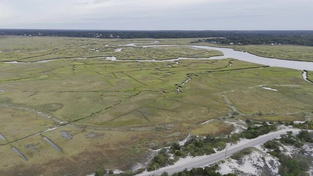 Aerial view of winding marshland waterways at low tide in Cape Cod, USA.
