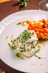 Portion of gourmet white fish with sauted vegetables