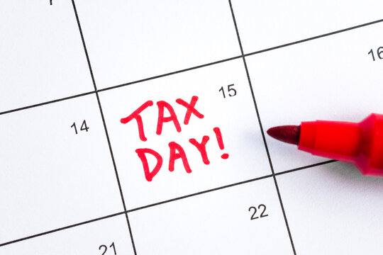 Close up shot of a calendar, with Tax Day reminder on the 15th and red marker pen. Deadline for filing Individual and Corporate Income Tax Return. Taxation, tax season, reminder, payment, extension