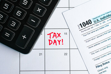 Top down shot of a calendar, with Tax Day reminder on the 15th, deadline for submission. With a...