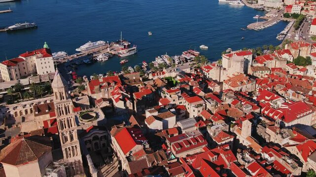 Aerial view of Split, Croatia with historic old town, Diocletians Palace and narrow streets and harbor near sea landscape in background. Adriatic coastline in coastal touristic city on summer day