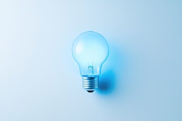 A glowing light bulb on a light blue background, symbolizing ideas, innovation, and inspiration.