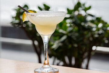 Margarita cocktail in a glass glass on a blurred background