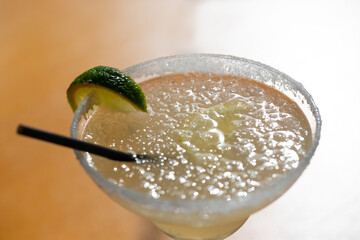 Margarita cocktail in a glass glass on a blurred background