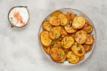 Crispy potato slices, with parmesan cheese and spices, fried in the oven, homemade, no people,