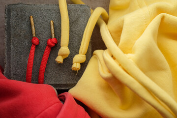 Texture and details hoodie drawstrings. Vibrant red drawstrings have gold-colored metal aglets....