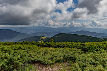 in a mountainous area in summer, there is nothing around but mountains