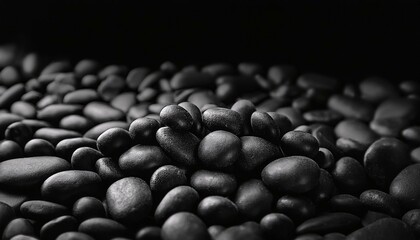 Fototapeta premium black background black pebbles of irregular shape evenly poured onto the surface monochrome photo