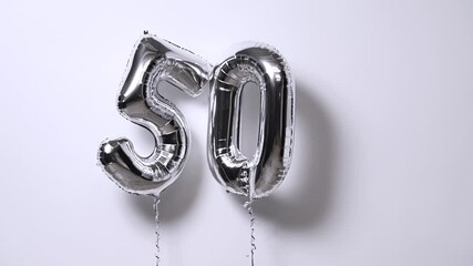 50 years birthday celebration silver balloons numbers five and zero
