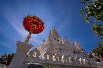 Wat phra that si mueang pong temple in Chiang Mai, Thailand. A golden Buddha statue stands...