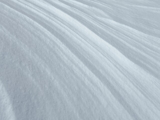 white abstract background of close-up natural snow texture. snow pattern. snow surface. nature pattern. abstract nature. linear pattern