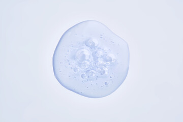 A drop of blue serum with bubbles.
