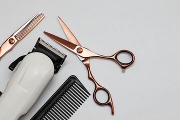 Hairdressing and barber tools. Professional scissors, hairdressing clipper and comb. White background.
