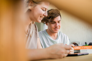 Man and woman watching a game console in a terrace in summer. Technology and game addiction concept