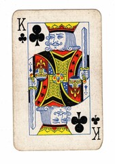 A well used, grubby playing card in the suit of clubs.